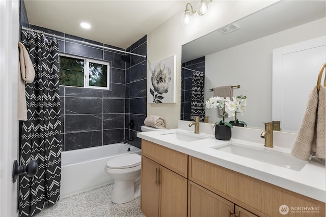 full bathroom featuring vanity, shower / tub combo with curtain, tile patterned floors, and toilet