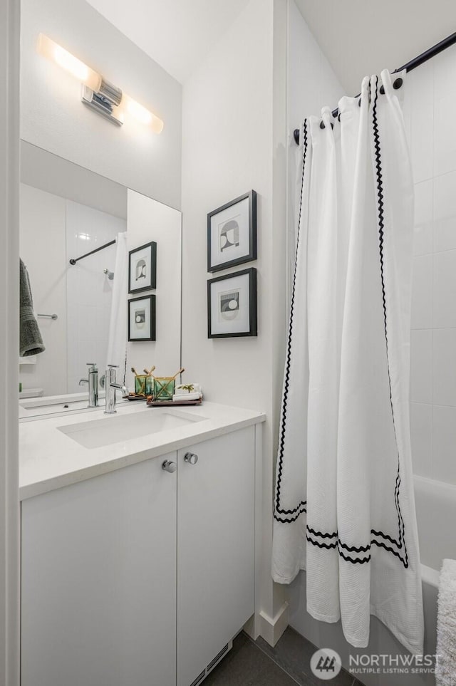 bathroom featuring vanity and shower / tub combo