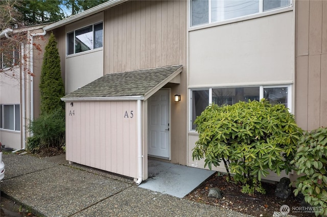 exterior space with roof with shingles