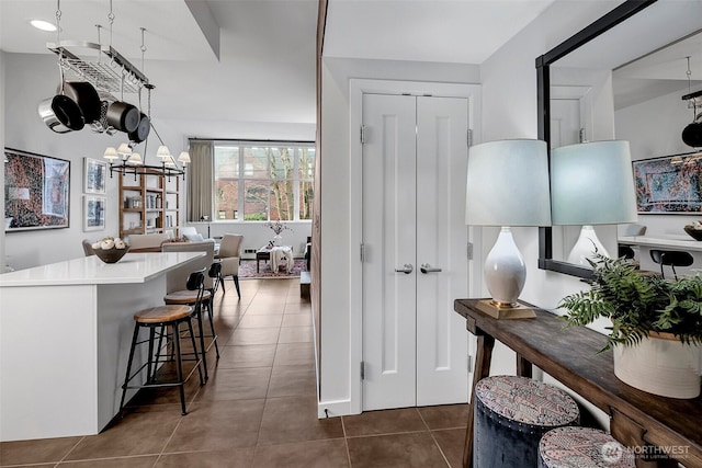 hall featuring dark tile patterned floors