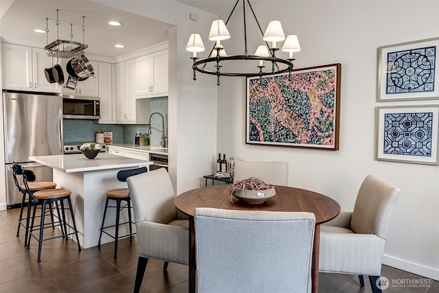 dining area featuring baseboards, dark tile patterned flooring, and recessed lighting