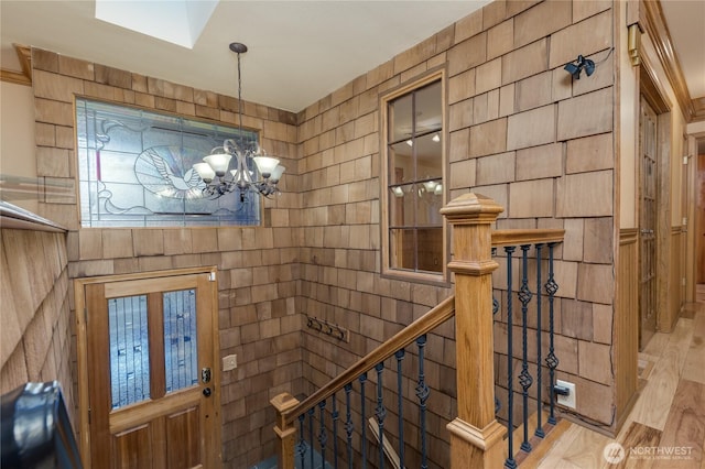 foyer entrance featuring a notable chandelier and light wood finished floors