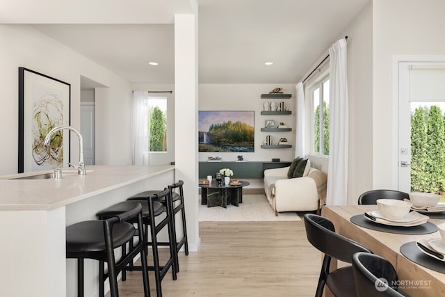 dining area featuring sink and light wood-type flooring