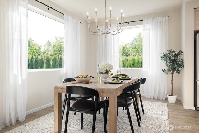 dining area featuring an inviting chandelier and light wood-type flooring