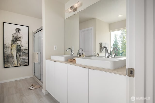 bathroom with walk in shower and vanity