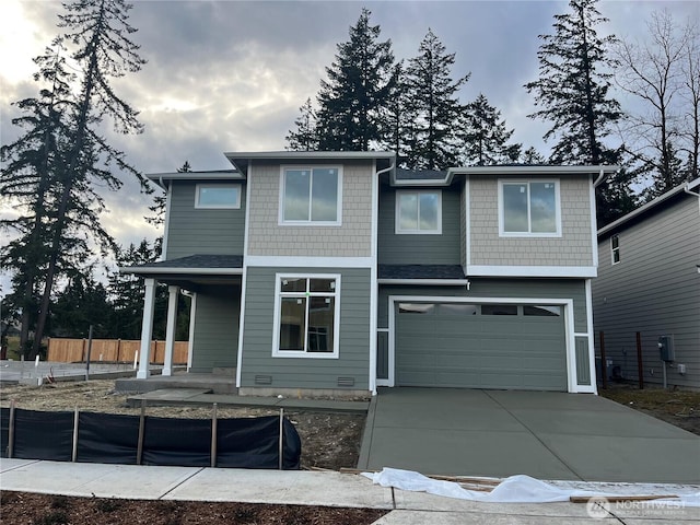 view of front of house featuring crawl space, driveway, an attached garage, and fence