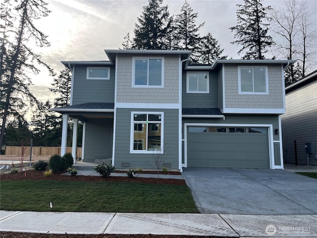 view of front facade featuring concrete driveway, an attached garage, fence, a porch, and a front yard