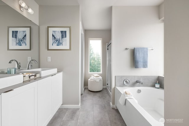 bathroom featuring vanity, tile patterned flooring, and separate shower and tub