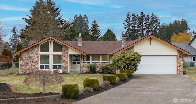 view of front of home with a garage and a front yard