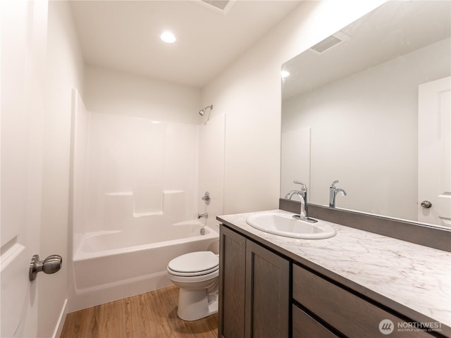 full bathroom with vanity, hardwood / wood-style flooring, toilet, and washtub / shower combination