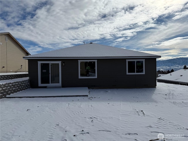 snow covered property with a mountain view