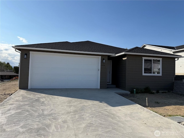 ranch-style house with an attached garage and driveway
