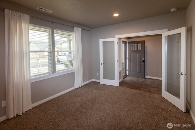 carpeted foyer with french doors