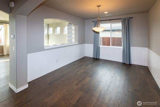 empty room with dark hardwood / wood-style flooring