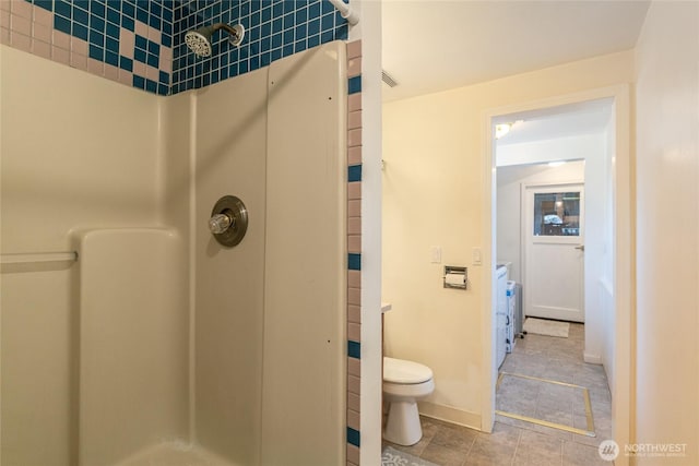 bathroom featuring toilet and a shower