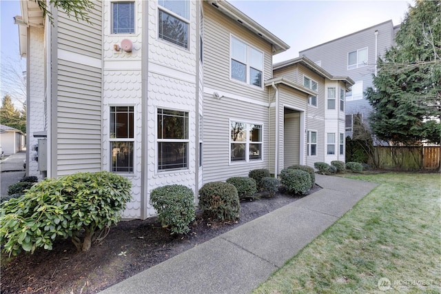 view of property exterior with a lawn