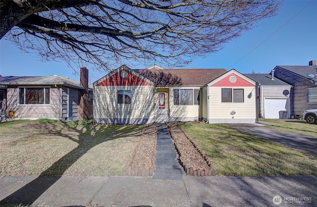 ranch-style home featuring a garage and a front lawn