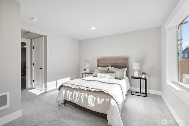 bedroom featuring light carpet