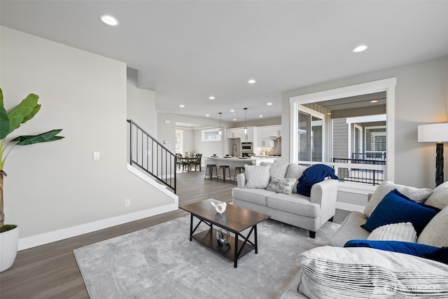 living room with dark hardwood / wood-style flooring and sink