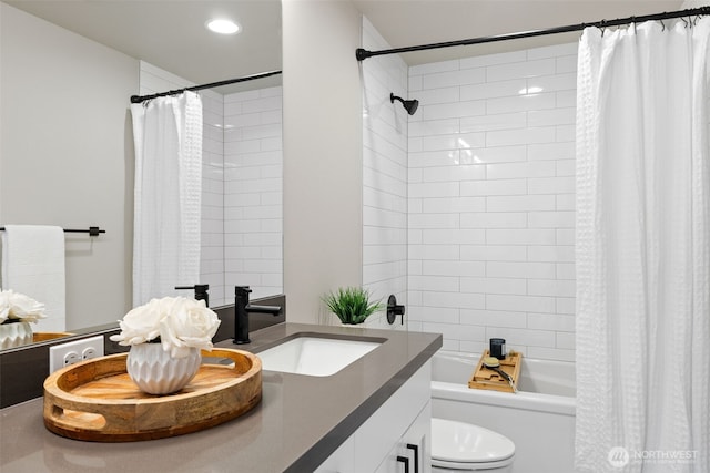 full bathroom featuring vanity, toilet, and shower / tub combo