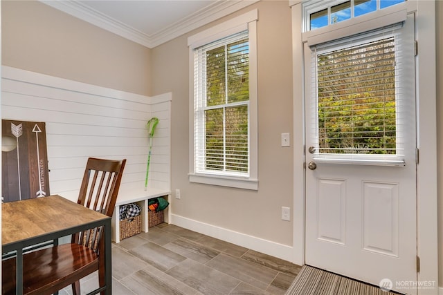 doorway to outside with crown molding and a wealth of natural light