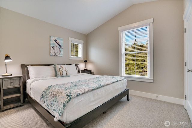 bedroom featuring light carpet and lofted ceiling