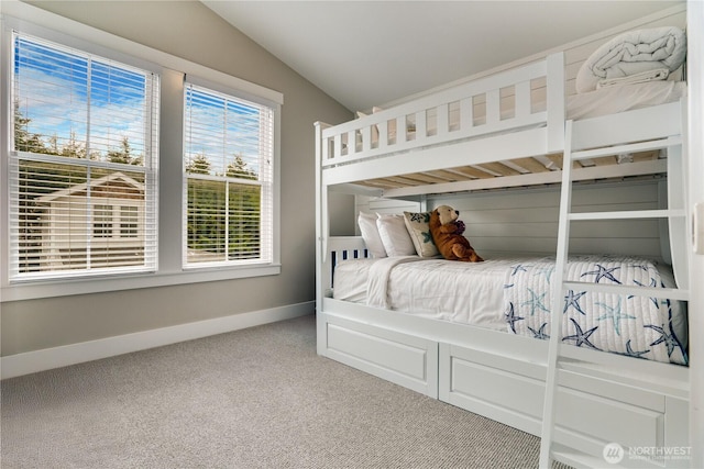 unfurnished bedroom with vaulted ceiling and carpet