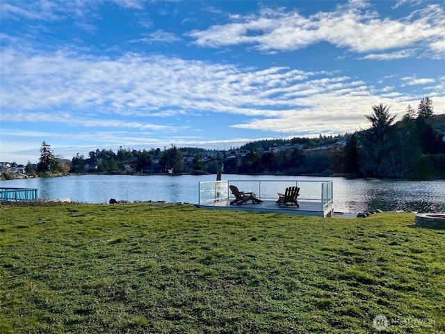 dock area featuring a water view and a yard