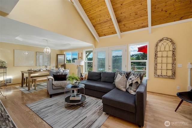 living room featuring a chandelier, light wood-type flooring, vaulted ceiling with beams, and wood ceiling