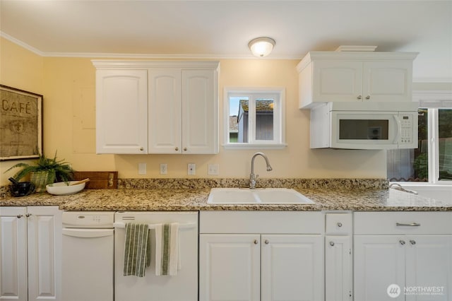 kitchen with a sink, ornamental molding, and white appliances