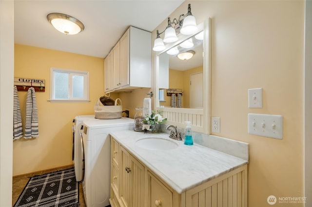bathroom featuring washer and dryer and vanity