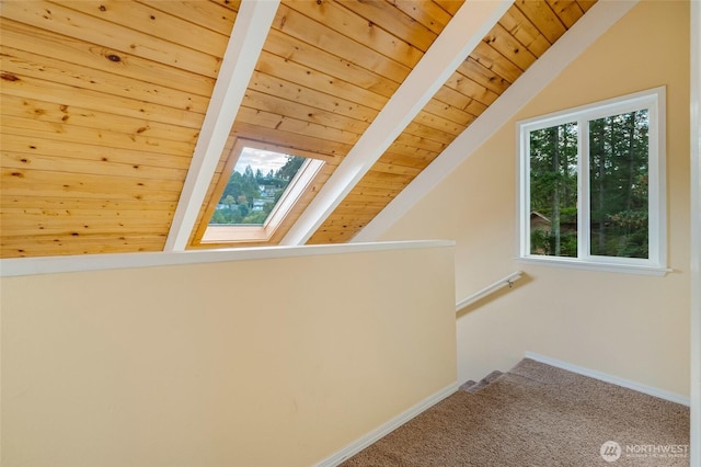 bonus room featuring vaulted ceiling with skylight, wood ceiling, baseboards, and carpet