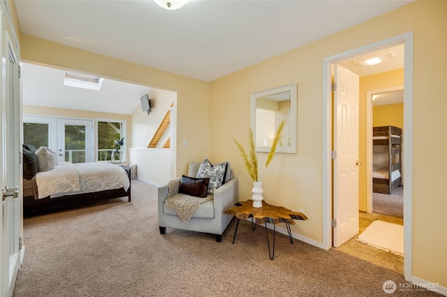 bedroom with carpet floors, a skylight, baseboards, and french doors