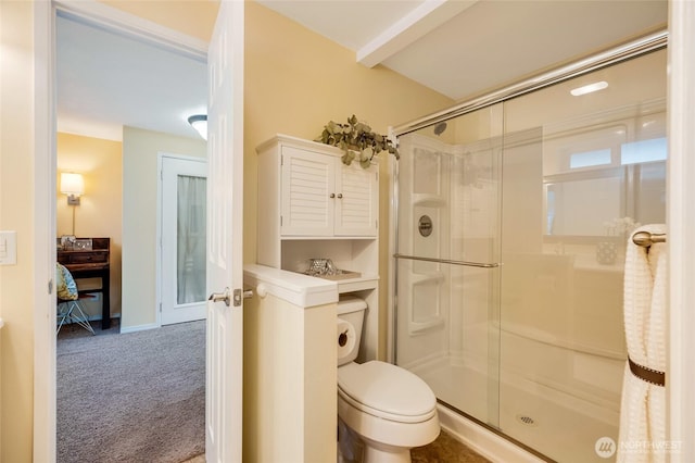 ensuite bathroom featuring toilet, a stall shower, and ensuite bathroom