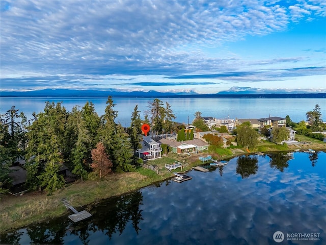 aerial view featuring a water and mountain view