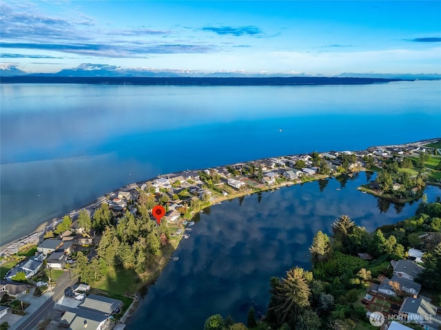 birds eye view of property with a water view and a residential view