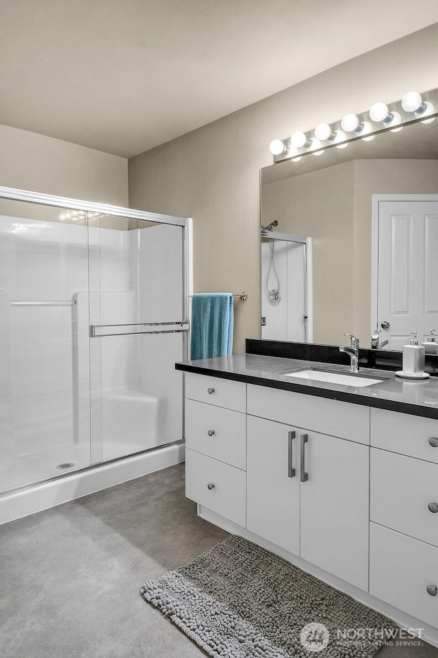 bathroom with a stall shower, vanity, and finished concrete floors