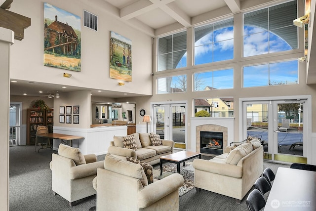 living area with carpet floors, coffered ceiling, visible vents, french doors, and beam ceiling