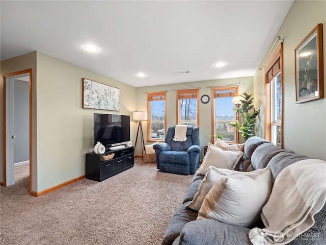 carpeted living area with baseboards, visible vents, and recessed lighting