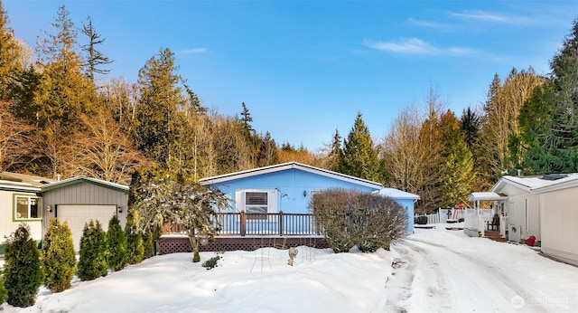 view of front of property featuring a garage and a wooden deck