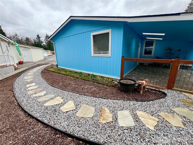 view of side of home with fence