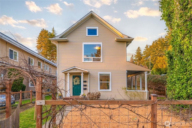 traditional-style home with a fenced front yard