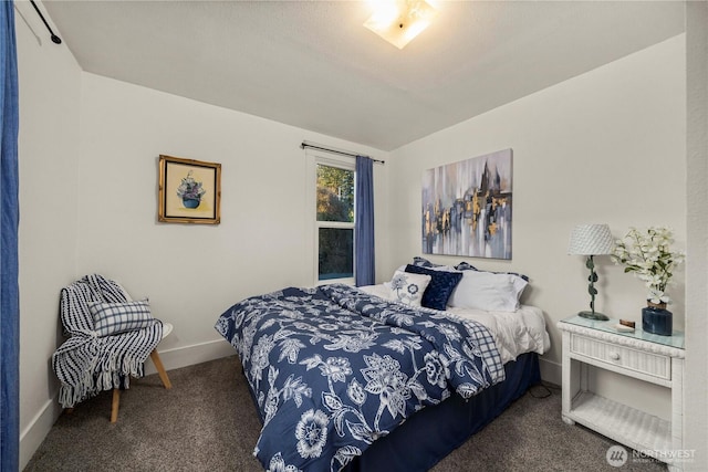 bedroom featuring carpet and baseboards