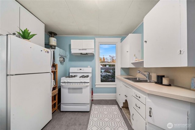 kitchen with white appliances, a sink, light countertops, white cabinets, and under cabinet range hood