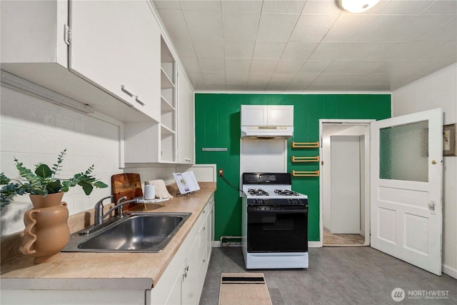 kitchen featuring open shelves, under cabinet range hood, gas range oven, white cabinetry, and a sink