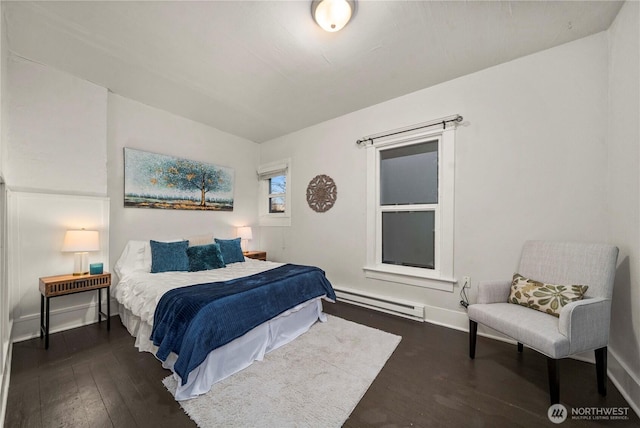 bedroom featuring dark wood-style floors, baseboards, and a baseboard radiator