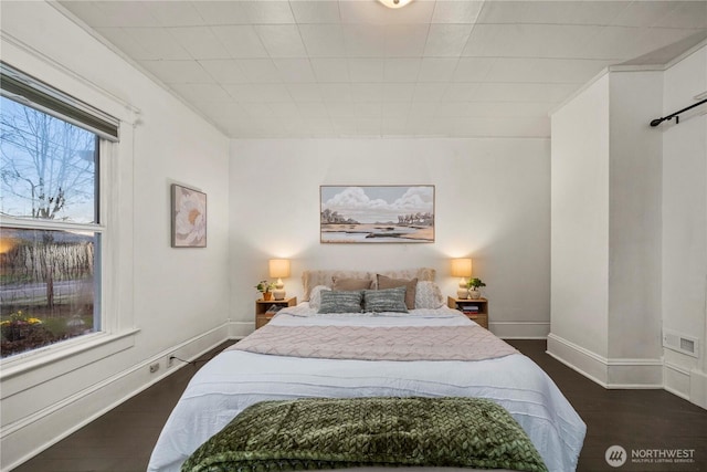 bedroom with visible vents, baseboards, and dark wood-style flooring