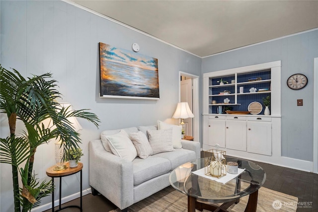 living room with wood finished floors, baseboards, and ornamental molding