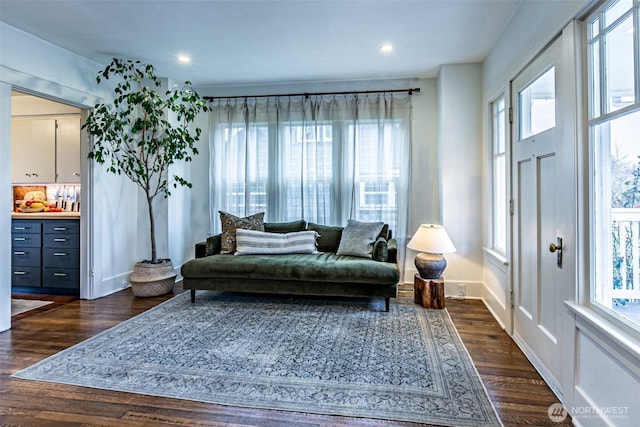 sitting room with dark wood-type flooring