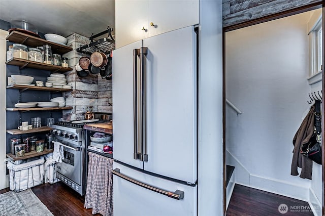 kitchen featuring high end appliances and dark hardwood / wood-style flooring